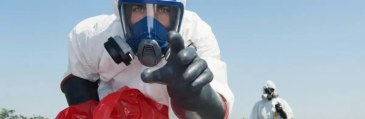 sewage clean up technician wearing protective gear handling biohazard materials in Overland Park, KS
