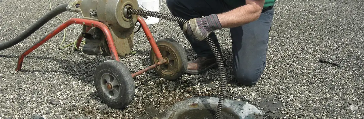 sewer rodding technician actively removing blockages from a sewer line in Overland Park, KS
